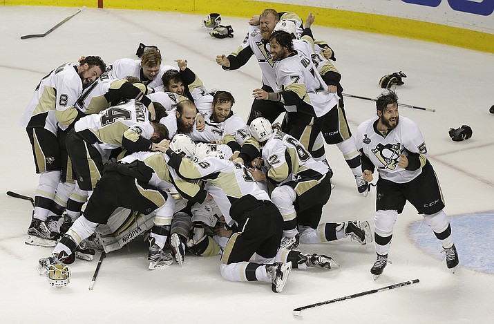 Pittsburgh Penguins players celebrate after beating the San Jose Sharks in Game 6 of the NHL hockey Stanley Cup Finals in San Jose, Calif., Sunday, June 12. The Penguins won 3-1 to win the series 4-2. 