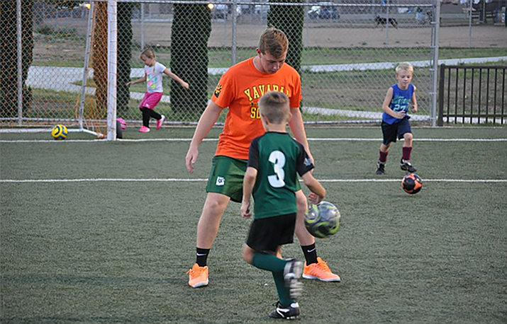 Darragh Boyle, a former Yavapai College soccer player, guides a youngster through a dribbling drill during a free Roughriders’ youth soccer clinic at Mountain Valley Park in Prescott Valley in August 2015. Boyle, who will play for the University of Benedictine at Mesa this fall, gained inspiration from a community service project he conducted for Donate Life Arizona during the 2016 spring semester at Yavapai.