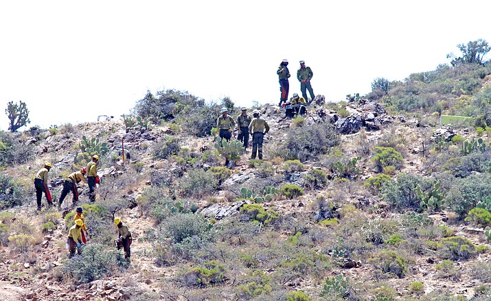A crew from Nevada does “contingency line work” in the hills south of Yarnell, in the ongoing effort to create fire breaks. Officials say the fire-break work that was done prior to the start of the Tenderfoot Fire helped to give firefighters the “upper hand” in dealing with the wildfire.
