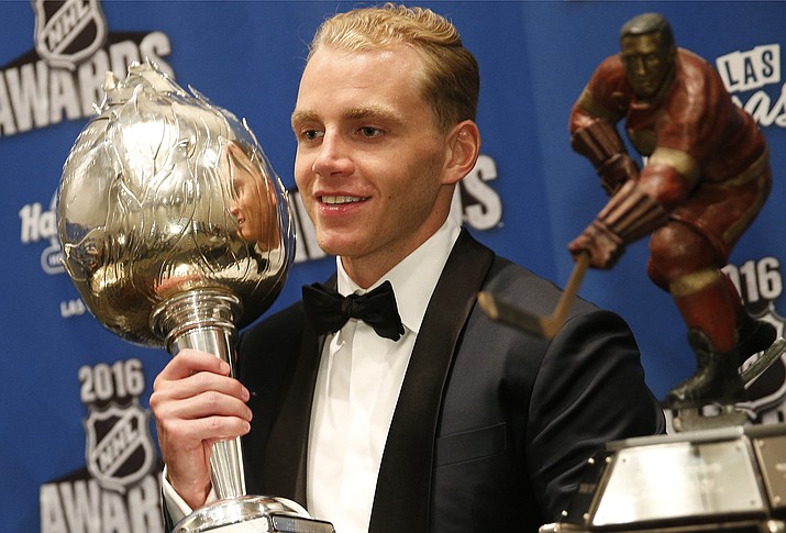 Chicago Blackhawks' Patrick Kane poses with the Hart Trophy, left, and the Ted Lindsay Award after winning the awards at the NHL Awards show, Wednesday, June 22, in Las Vegas. 