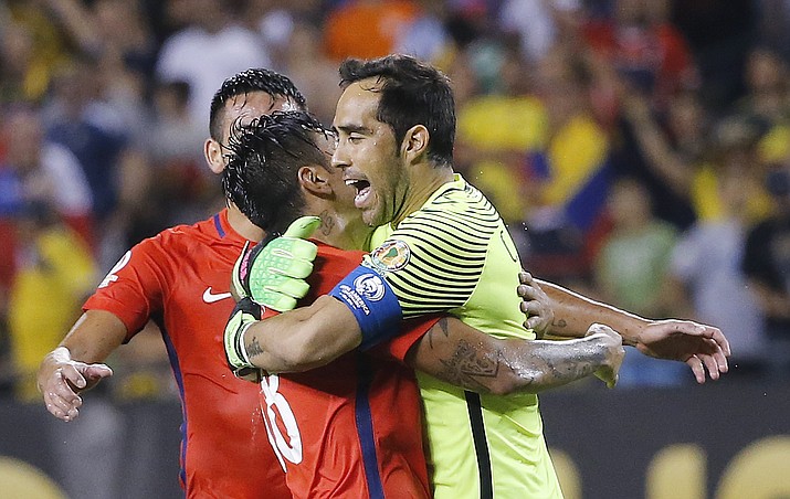 Chile goalkeeper Claudio Bravo, right celebrates with Chile's Mauricio Isla (4) and other players during a Copa America Centenario semifinal soccer match at Soldier Field in Chicago, Wednesday, June 22. Chile won 2-0.