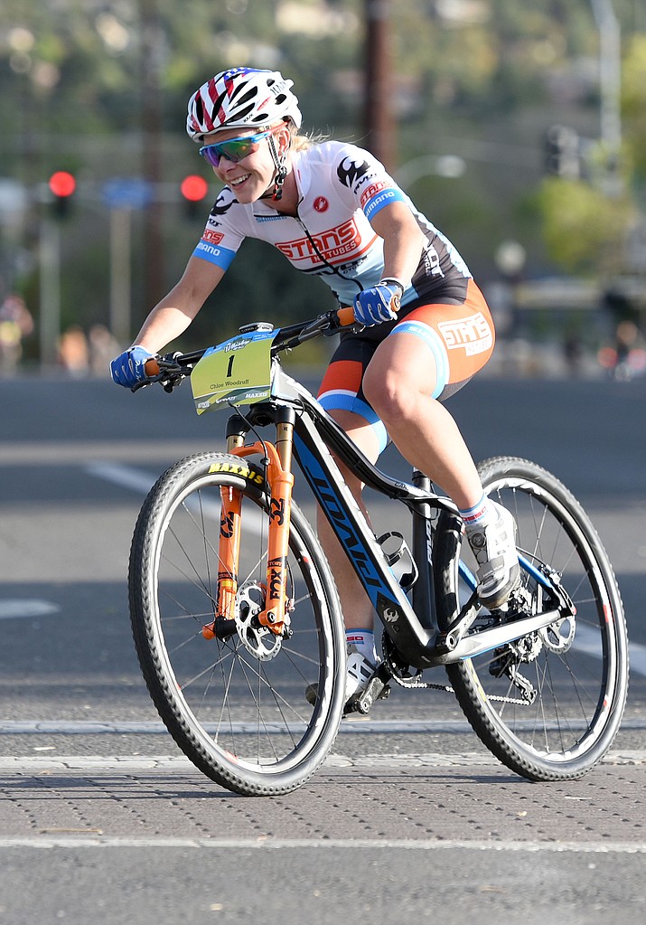 Chloe Woodruff rockets through a turn Friday evening April 29, 2016 during the 13th Annual Whiskey Off-Road Fat Tire Criterium in downtown Prescott.  Wodruff finished the race in third place. 