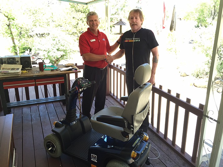 Vietnam veteran Bill Springer receives a free electric wheelchair from Gary Denton who recently began restoring donated wheelchairs and giving them away to veterans as part of his new not-for-profit effort, the Wheels of Freedom Project. 