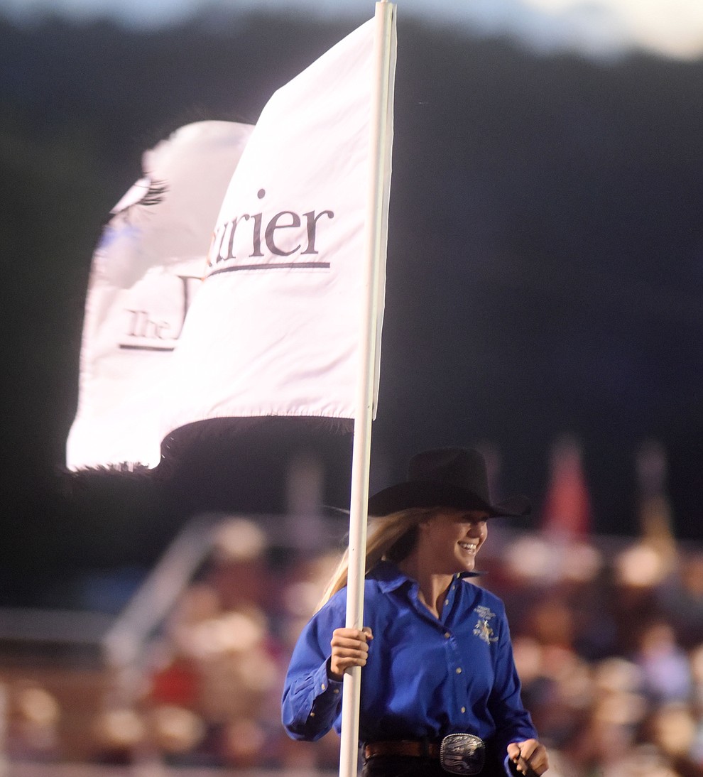 The Daily Courier flag flys between rounds during the first round of the Prescott Frontier Days Rodeo Tuesday night. (Les Stukenberg/The Daily Courier)