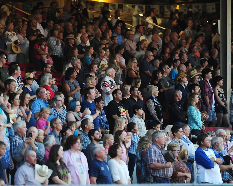A large crowd sings the National Anthem during the first round of the Prescott Frontier Days Rodeo Tuesday night. (Les Stukenberg/The Daily Courier)