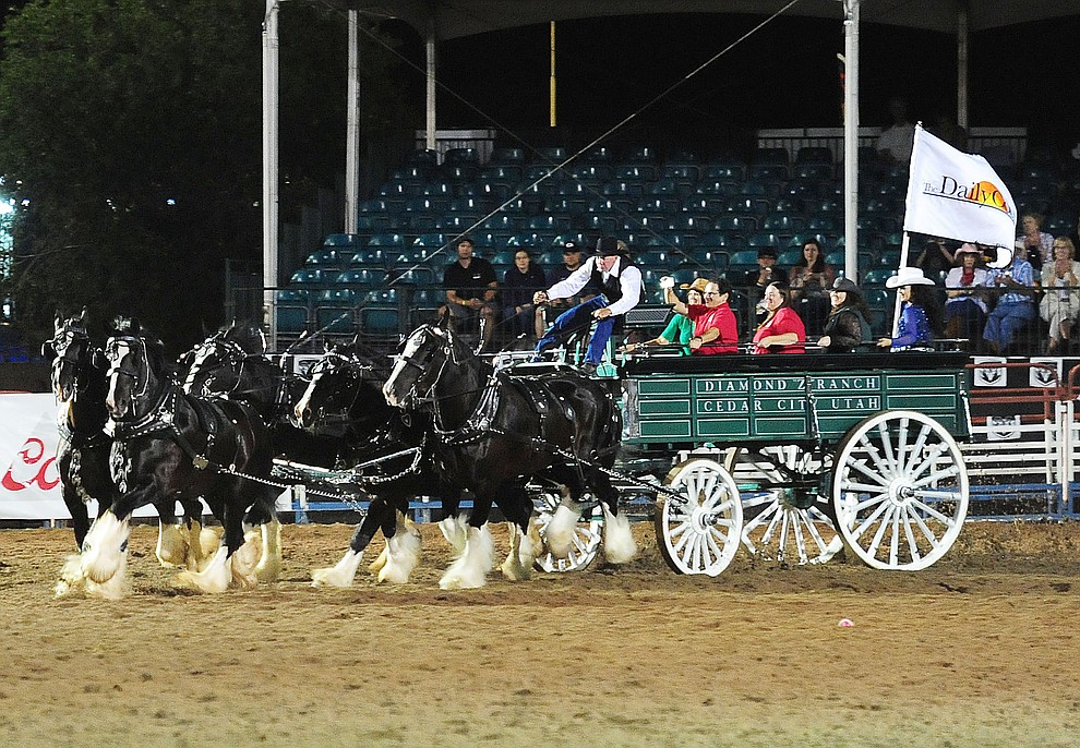 The Diamond Z English Shire Horses head to home during the first round of the Prescott Frontier Days Rodeo Tuesday night. (Les Stukenberg/The Daily Courier)