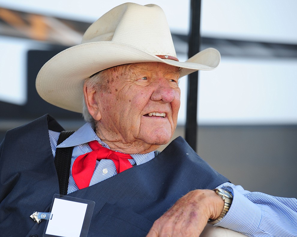Harry Vold keeps an eye on the action behind the chutes before the first round of the Prescott Frontier Days Rodeo Tuesday night. (Les Stukenberg/The Daily Courier)