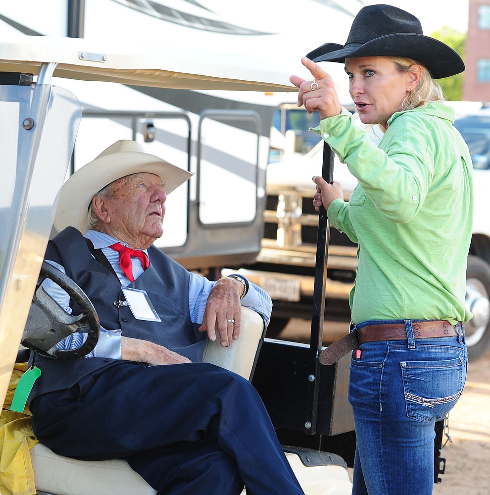 Harry and Kristen Vold talk before the first round of the Prescott Frontier Days Rodeo Tuesday night. (Les Stukenberg/The Daily Courier)