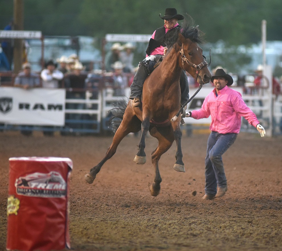 The TC Buntin team bucks it's way to the finish line in the wild horse race during the first round of the Prescott Frontier Days Rodeo Tuesday night. (Les Stukenberg/The Daily Courier)