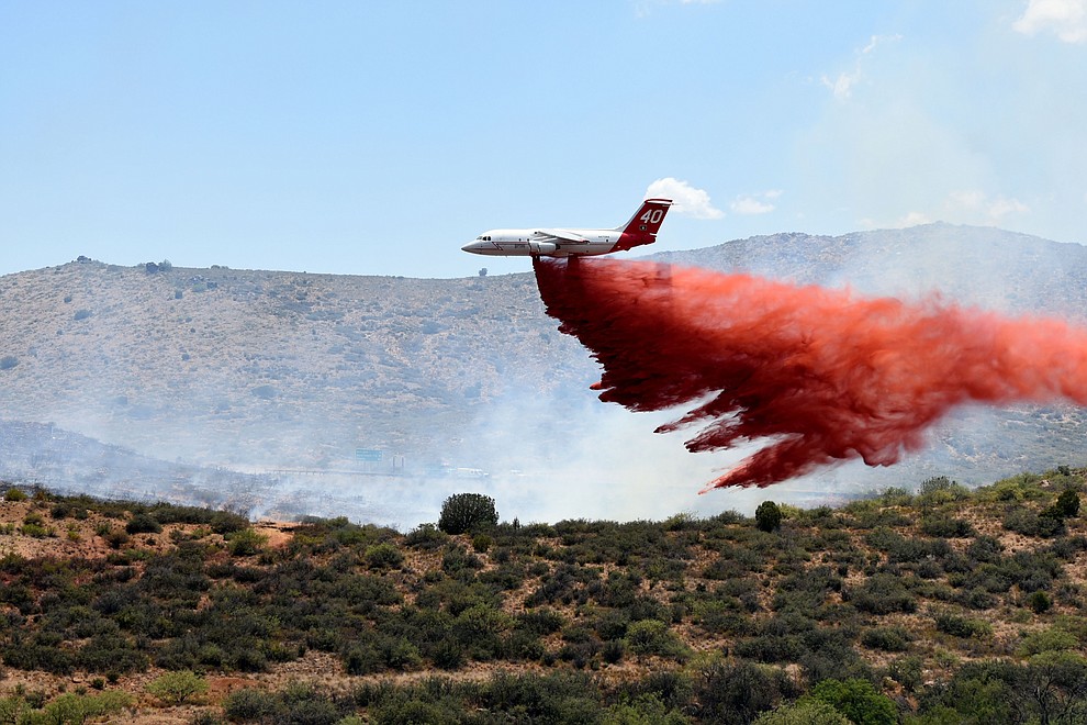A heavy air tanker drops a load of retardent to create fire lines on the Bug Creek Fire near Cordes Lakes Tuesday afternoon. (Les Stukenberg/The Daily Courier)