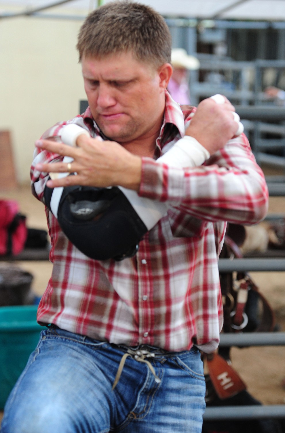 Heath Ford tapes himself up before his bareback ride during the second round of the Prescott Frontier Days Rodeo Wednesday night. (Les Stukenberg/The Daily Courier)