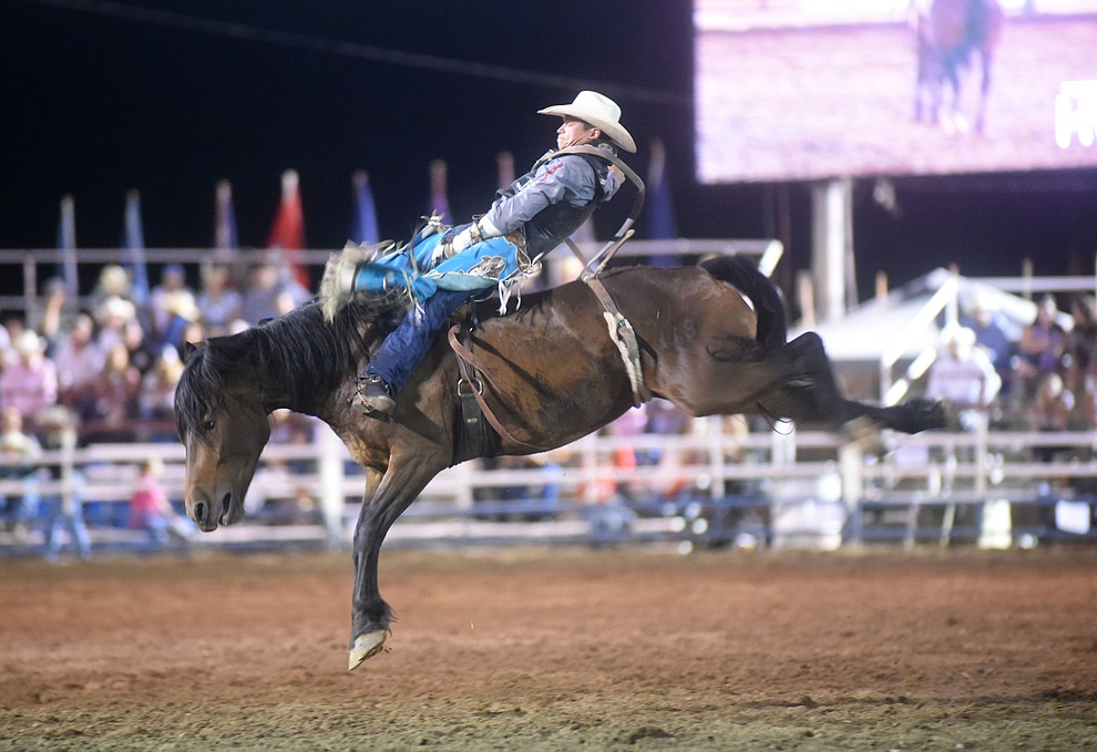 Tanner Aus rides Frisky Chicken in the bareback for an 82.5 score during the second round of the Prescott Frontier Days Rodeo Wednesday night. (Les Stukenberg/The Daily Courier)