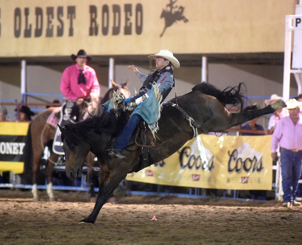 Tanner Aus rides Frisky Chicken in the bareback for an 82.5 score during the second round of the Prescott Frontier Days Rodeo Wednesday night. (Les Stukenberg/The Daily Courier)