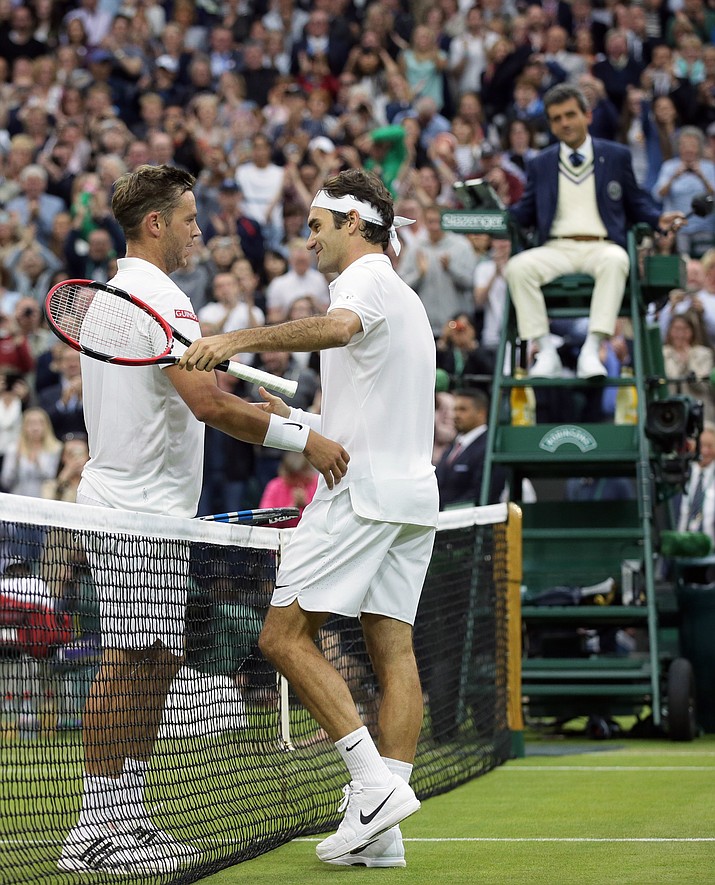 Roger Federer of Switzerland, right, shakes hands with Marcus Willis of Britain after beating him in their men's singles match on day three of the Wimbledon Tennis Championships in London, Wednesday, June 29.