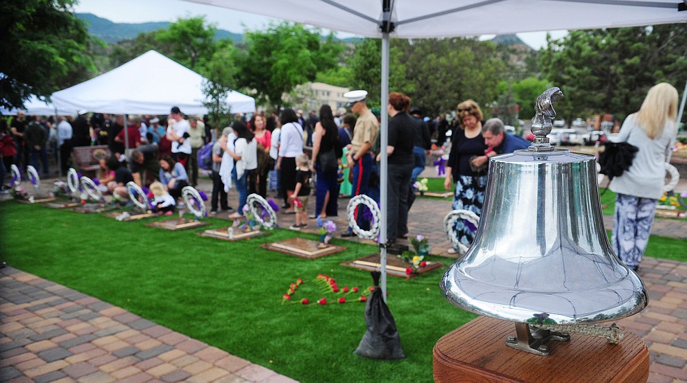 Family members, friends and coworkers pay their respects following a Celebration of Remembrance ceremony at the Arizona Pioneer's Home Cemetery on the third anniversary of the death's of the 19 Granite Mountain Hotshots while fighting the Yarnell Hill Fire. (Les Stukenberg/The Daily Courier)