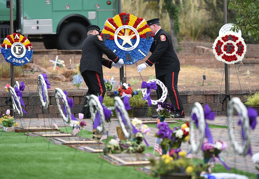 Honor Guard members place a wreath during a Celebration of Remembrance ceremony at the Arizona Pioneer's Home Cemetery on the third anniversary of the death's of the 19 Granite Mountain Hotshots while fighting the Yarnell Hill Fire. (Les Stukenberg/The Daily Courier)