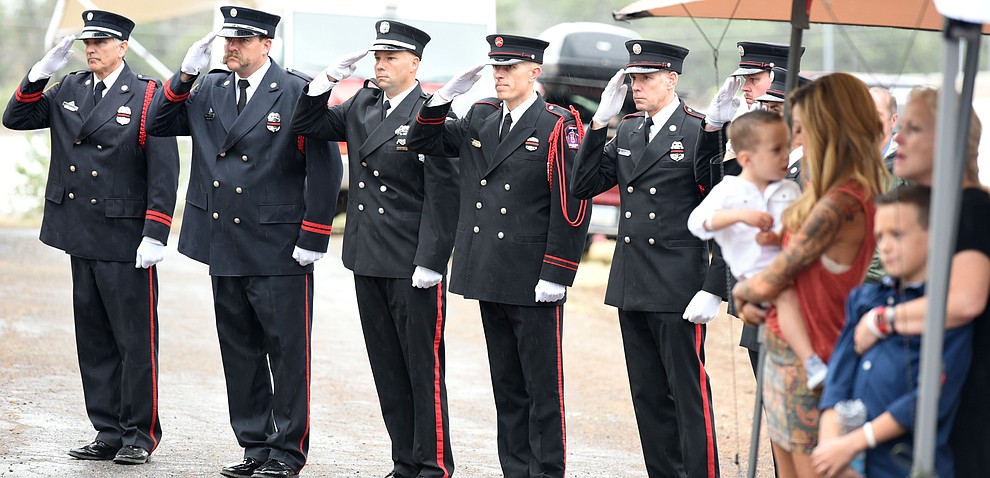 Honor Guard members salute during the reading of the names during a Celebration of Remembrance ceremony at the Arizona Pioneer's Home Cemetery on the third anniversary of the death's of the 19 Granite Mountain Hotshots while fighting the Yarnell Hill Fire. (Les Stukenberg/The Daily Courier)