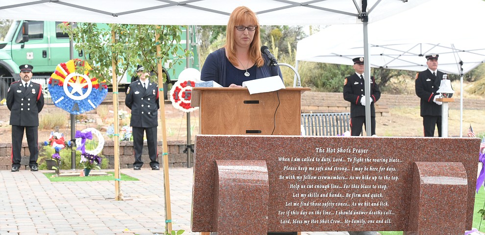 Trish Huston, author of the Hotshot's Prayer and wife of a Hotshot Superintendent, reads the prayer during a Celebration of Remembrance ceremony at the Arizona Pioneer's Home Cemetery on the third anniversary of the death's of the 19 Granite Mountain Hotshots while fighting the Yarnell Hill Fire. (Les Stukenberg/The Daily Courier)