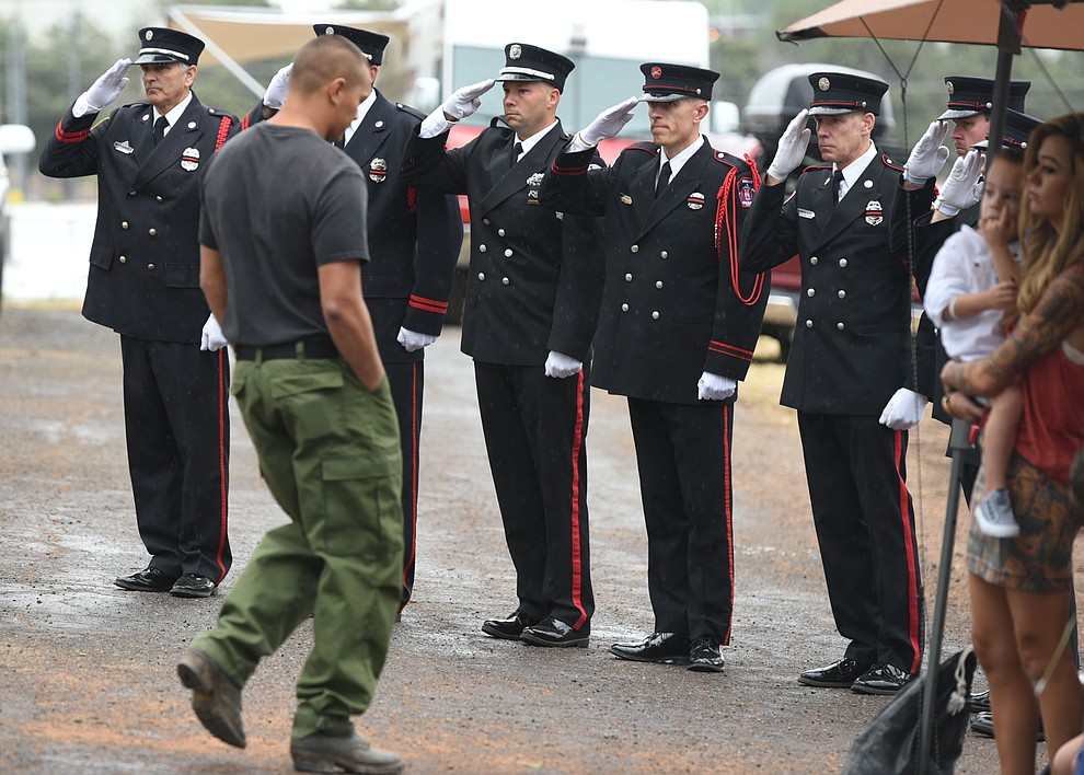 Honor Guard members salute after former GMHS Shane Arrollado read the names during a Celebration of Remembrance ceremony at the Arizona Pioneer's Home Cemetery on the third anniversary of the death's of the 19 Granite Mountain Hotshots while fighting the Yarnell Hill Fire. (Les Stukenberg/The Daily Courier)