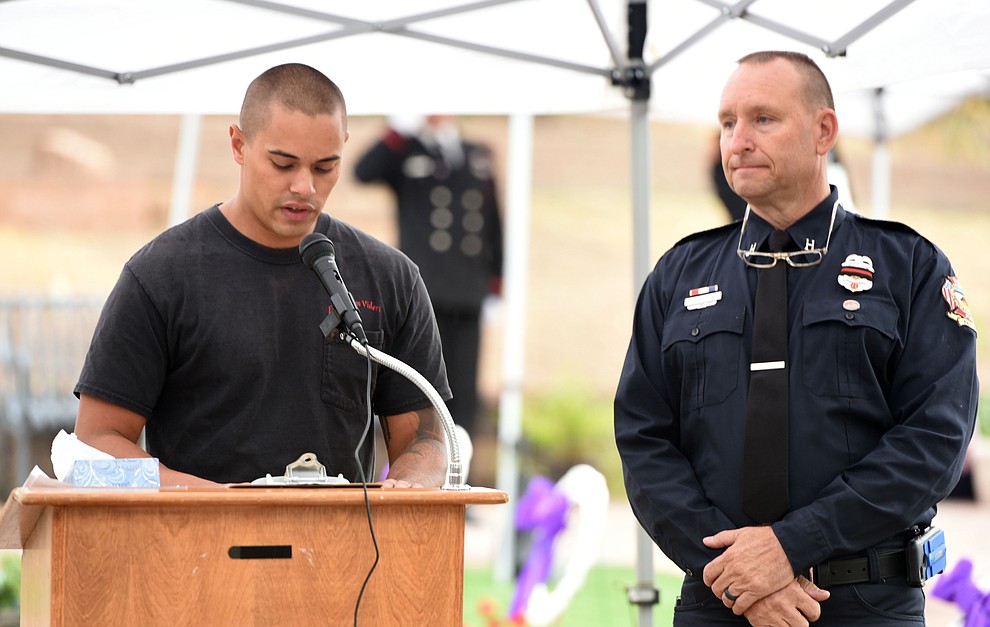 Tom Haney looks on as former Granite Mountain Hotshot Shane Arrollado reads the names of the fallen during a Celebration of Remembrance ceremony at the Arizona Pioneer's Home Cemetery on the third anniversary of the death's of the 19 Granite Mountain Hotshots while fighting the Yarnell Hill Fire. (Les Stukenberg/The Daily Courier)