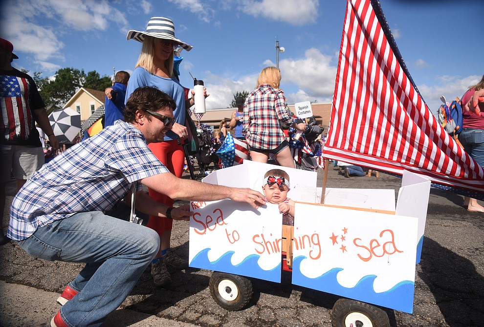 Joe Thornhill gets his daughter Lake and her mini-sailboat ready for the 75th annual Kiwanis Kiddie Parade through downtown Prescott. (Les Stukenberg/The Daily Courier)