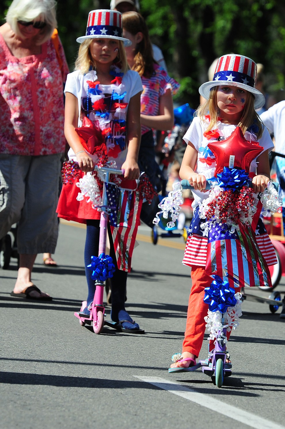 Scooters scoot here and there during the 75th annual Kiwanis Kiddie Parade through downtown Prescott Friday morning. (Les Stukenberg/The Daily Courier)