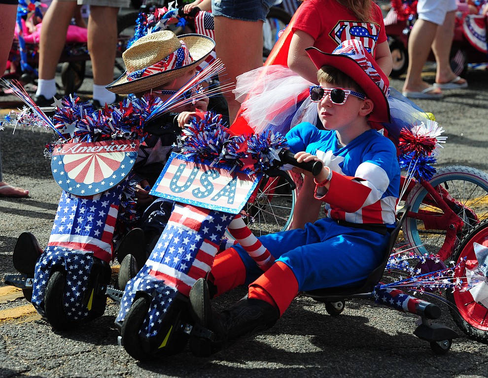 Superheroes on decorated trikes during the 75th annual Kiwanis Kiddie Parade through downtown Prescott Friday morning. (Les Stukenberg/The Daily Courier)