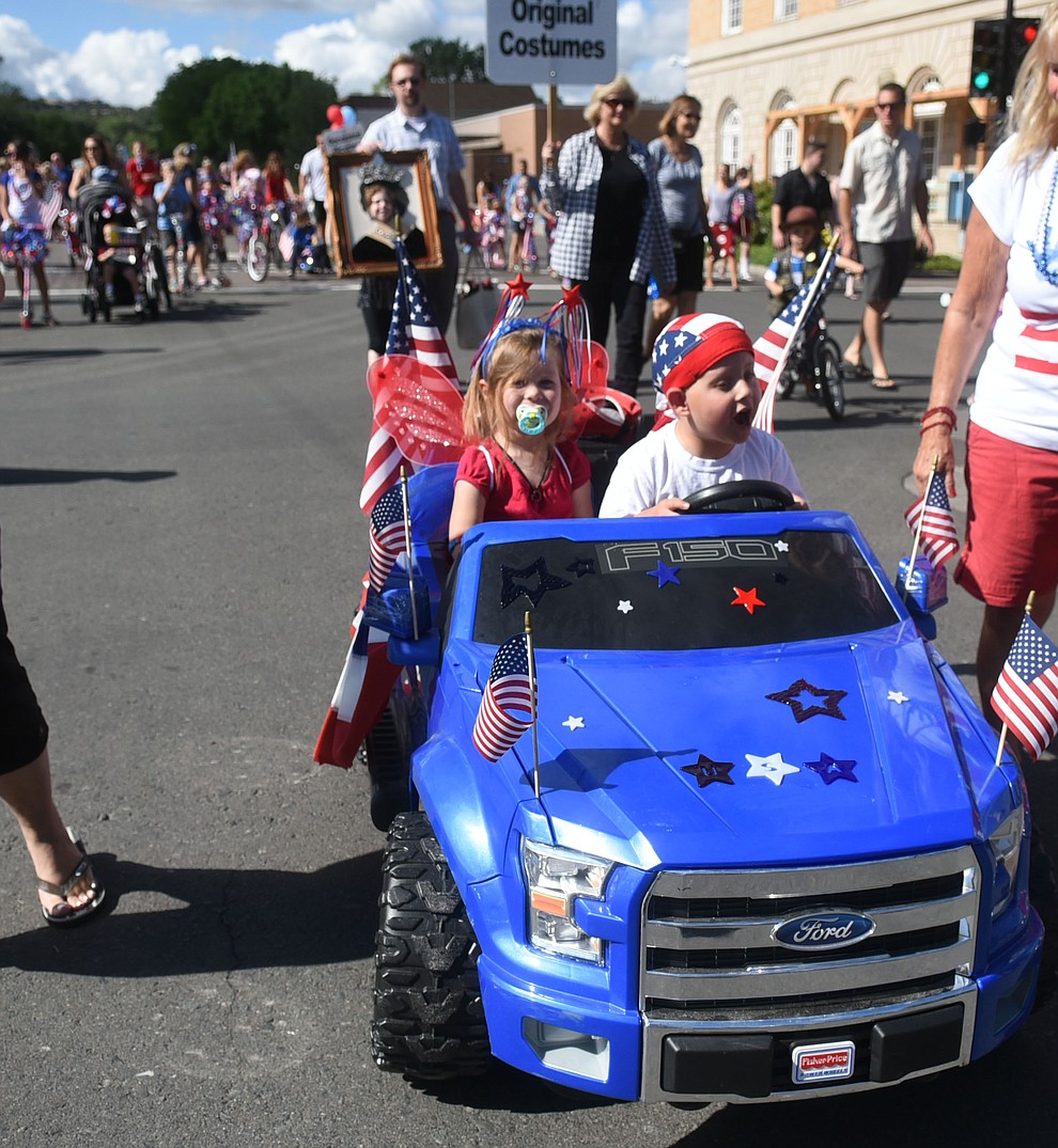 Patriotic cruising during the 75th annual Kiwanis Kiddie Parade through downtown Prescott Friday morning. (Les Stukenberg/The Daily Courier)