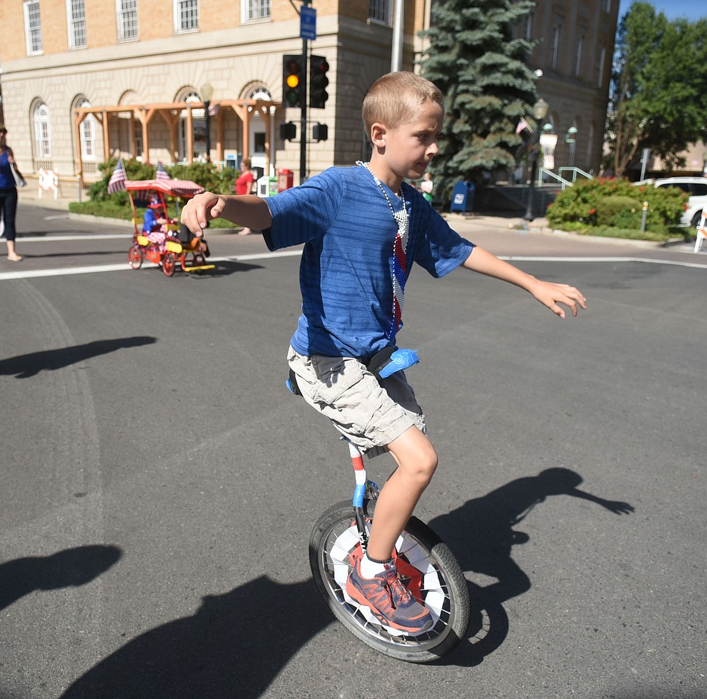Why have two wheels when one will do during the 75th annual Kiwanis Kiddie Parade through downtown Prescott Friday morning. (Les Stukenberg/The Daily Courier)