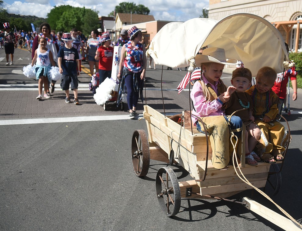 A covered wagon heads down Cortez Street during the 75th annual Kiwanis Kiddie Parade through downtown Prescott Friday morning. (Les Stukenberg/The Daily Courier)