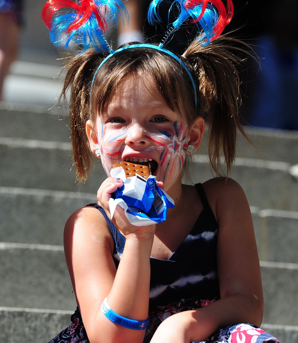 Ella Pifer enjoys her ice cream sandwich following the 75th annual Kiwanis Kiddie Parade through downtown Prescott Friday morning. (Les Stukenberg/The Daily Courier)