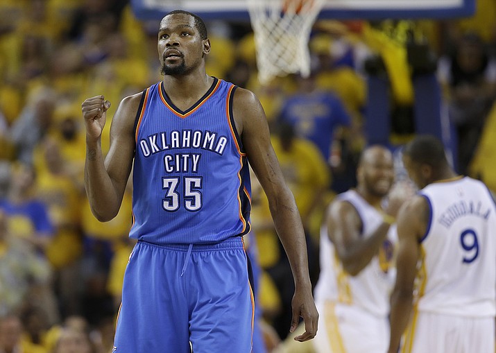 Oklahoma City Thunder forward Kevin Durant, left, reacts during Game 7 of the NBA basketball Western Conference finals against the Golden State Warriors in Oakland, Calif. 