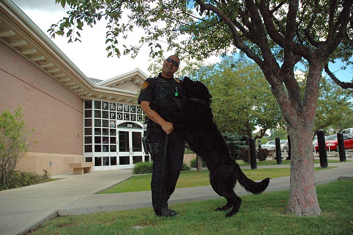 Prescott Police Officer Dan Smith works with his K-9 dog Corey in front of the Prescott Police Department. Smith and Corey will be among the K-9 teams participating in a free public demo at the Prescott Rodeo Grounds on July 19.