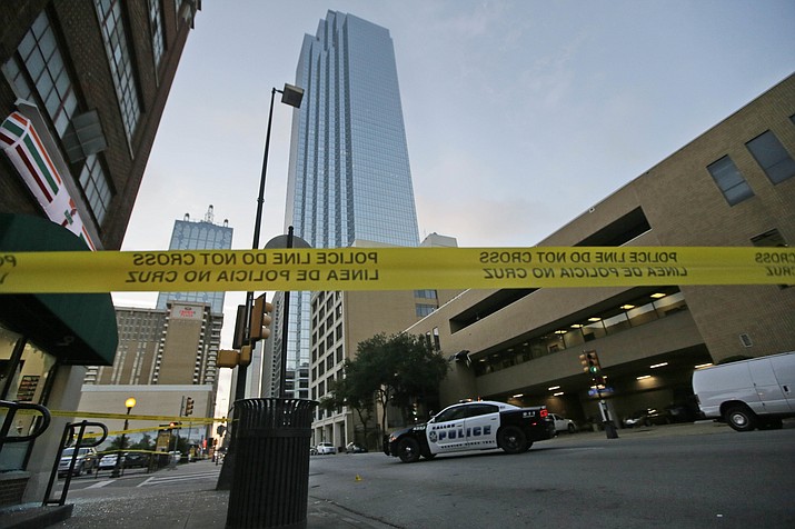 Police tape marks off the area where a shooting took place in downtown Dallas, Friday, July 8, 2016. Snipers opened fire on police officers in the heart of Dallas during protests over two recent fatal police shootings of black men. 