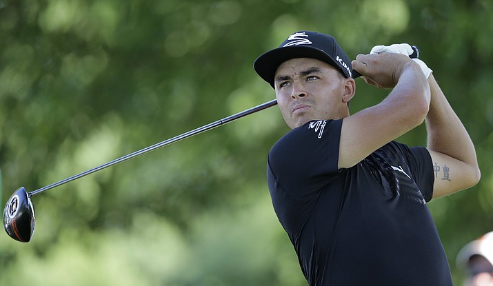 Rickie Fowler tees off on the 18th hole during the Bridgestone Invitational golf tournament at Firestone Country Club, in Akron, Ohio, in June.  Fowler said on Twitter on Sunday, July 10, that he’s going to the Olympics. 