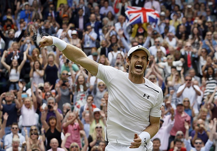 Andy Murray of Britain celebrates after beating Milos Raonic of Canada in the men's singles final on day 14 of the Wimbledon Tennis Championships in London, Sunday, July 10.
