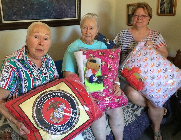 From Home With Love founder Gerda Samuels, left, Ruth Clarkson, center, and Shawn Stencel, right with the handmade pillowcases and pillows they are shipping overseas to military troops.