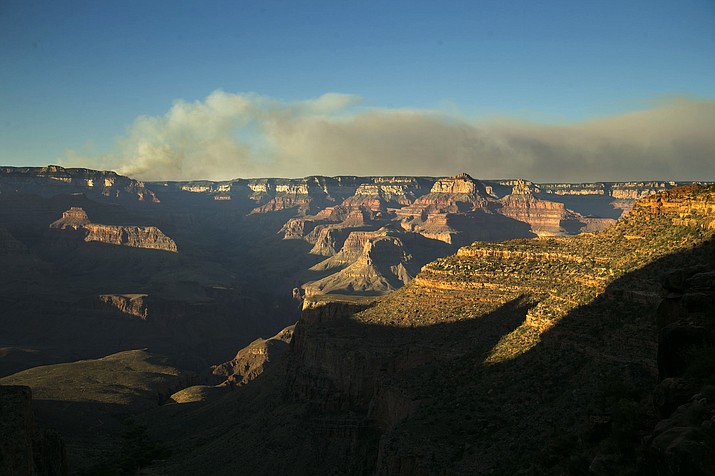A wildfire burns on the north rim of the Grand Canyon as seen from the Bright Angel Trail below the south rim of the canyon in Grand Canyon National Park in Arizona, Thursday, July 14, 2016. 