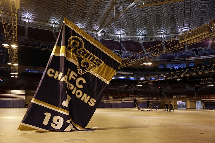 Championship banners are removed from the ceiling of the Edward Jones Dome, former home of the St. Louis Rams football team, in January 2016 in St. Louis. “Upheaval” is the buzzword for the NFL as training camps open, such as the Rams being the first shifting of an NFL franchise since the Oilers moved to Tennessee in 1997.
