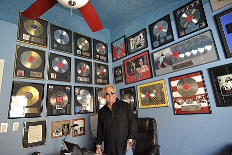 Bob Conrad poses with some of his music-industry memorabilia. In his 45-year career, he worked with some of the biggest bands around and helped others become big.