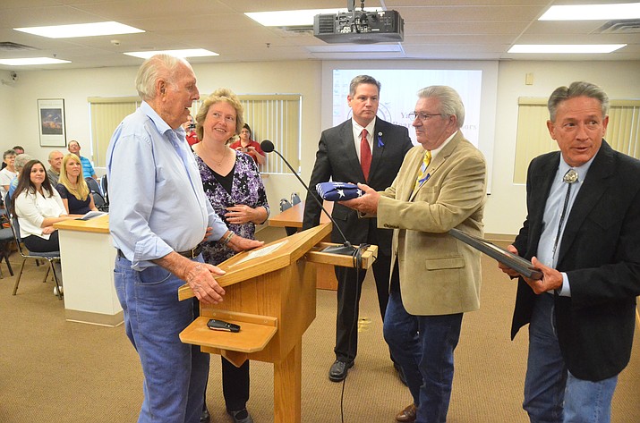 World War II Navy veteran James L. Oliver, left, with his granddaughter, Kathy Silvas, at his side, is presented with a flag by Supervisor Craig Brown in honor of Oliver’s 100th birthday on July 2. Also pictured are Board Chairman Jack Smith, center, and Supervisor Chip Davis, far right. 

