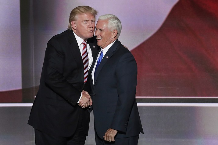 Republican Presidential Candidate Donald Trump, give his running mate Republican Vice Presidential Nominee Gov. Mike Pence of Indiana a kiss after Pence's acceptance speech during the third day of the Republican National Convention in Cleveland, Wednesday, July 20, 2016. 