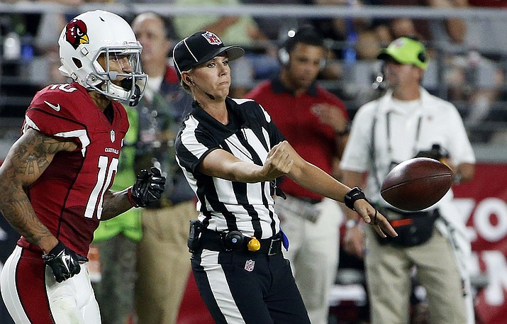 NFL official Sarah Thomas tosses the ball back to the line of scrimmage as Arizona Cardinals' Brittan Golden heads into the game during the Aug. 15, 2015, NFL preseason football game against the Kansas City Chiefs in Glendale. Thomas, who was the first female to be a full-time game official in the NFL will again be the NFL's only female game official in 2016.
