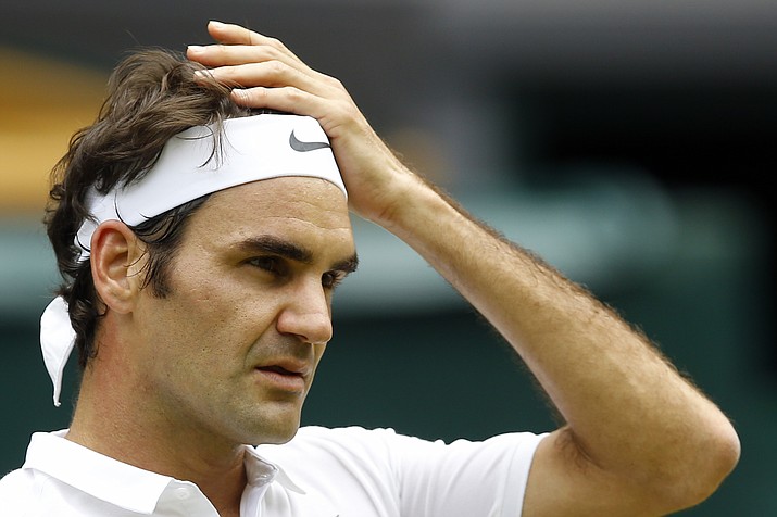 In this July 4, 2016, file photo, Roger Federer of Switzerland looks on during his men's singles match against Steve Johnson at the Wimbledon Tennis Championships in London. Federer says he will miss the Rio Olympics and the rest of the tennis season to protect his surgically repaired left knee. Federer writes Tuesday, July 26, 2016, on his Facebook page that he will skip the Summer Games, where the tennis competition starts next week, and has been advised by doctors to remain sidelined for the remainder of 2016.