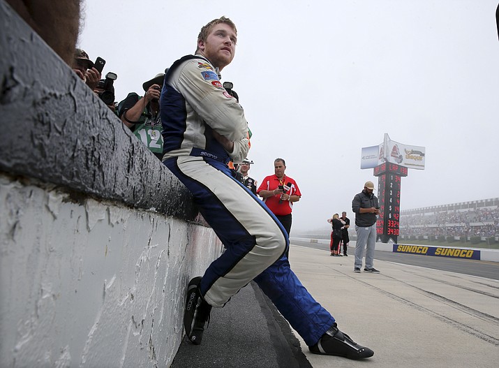 Chris Buescher sits on pit wall waiting to be declared winner of the rain-shortened NASCAR Sprint Cup Series Pennsylvania 400 auto race at Pocono Raceway, Monday, Aug. 1.