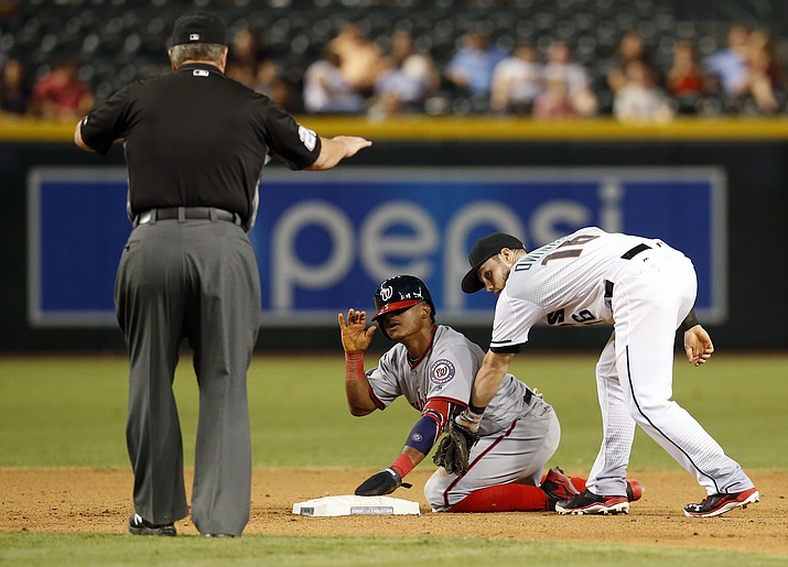 Washington Nationals' Wilmer Difo is tagged late by Arizona Diamondbacks' Chris Owings (16) after stealing second base during the eighth inning of a baseball game, Tuesday, Aug. 2, in Phoenix.