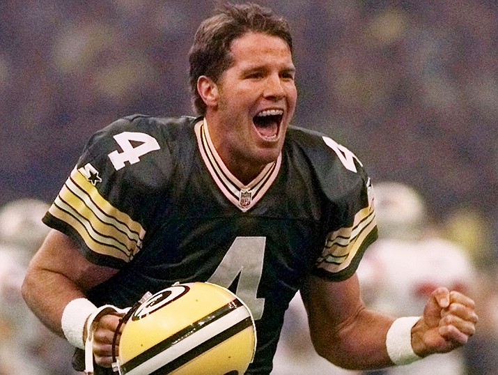 In this Jan. 26, 1997, file photo, Green Bay Packers quarterback Brett Favre celebrates after throwing a touchdown pass to Andre Rison during Super Bowl XXXI in New Orleans. Favre was inducted into the Pro Football Hall of Fame on Saturday, Aug. 6, in Canton, Ohio. (AP Photo/Doug Mills, File)