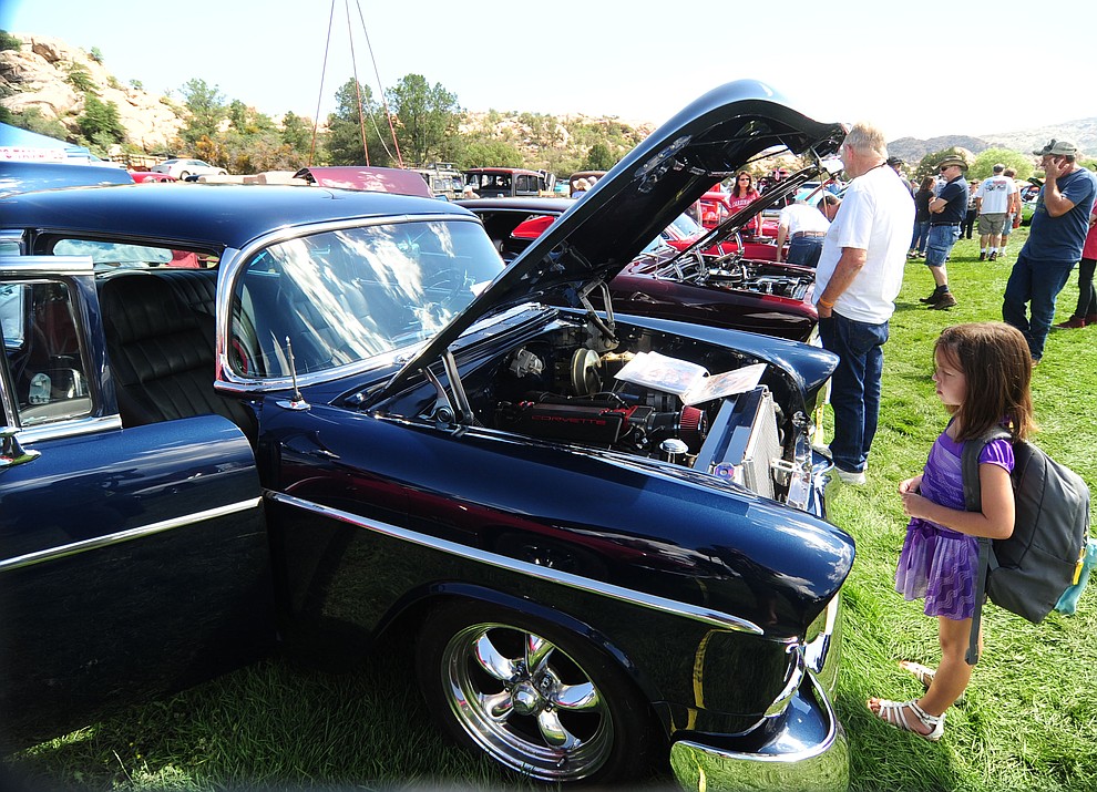 Young and old alike take in the hundreds of cars, trucks, and parts vendors at the 42nd Annual Prescott Antique Auto Club show at Watson Lake Park Saturday. The show continues all day on Sunday.  (Les Stukenberg/The Daily Courier)