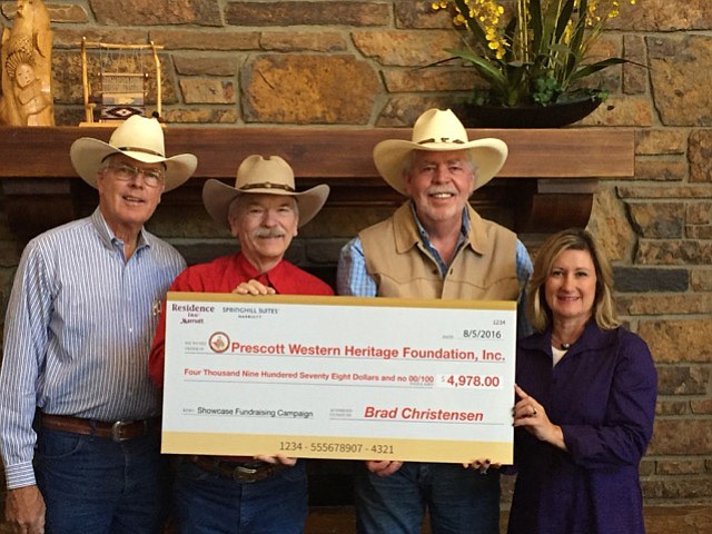 Margo Christensen, V.P. of Marketing and Public Relations at Ponderosa Hotel Management, presents a donation of $4,978.00 to (left to right) Jim Buchanan, Dennis Gallagher, and Dennis Jennings, Prescott Western Heritage Foundation, Inc. 