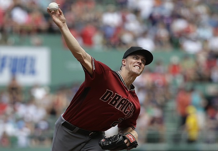 Arizona Diamondbacks' Zack Greinke delivers a pitch against the Boston Red Sox in the first inning of a baseball game, Sunday, Aug. 14, in Boston.